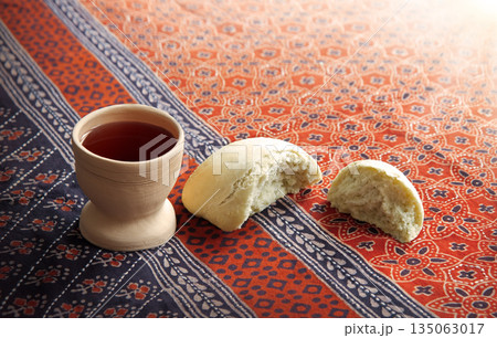 Wine in a gobled and bread 135063017