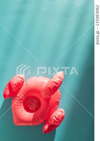 Pink Flamingo Shaped Pool Float on Turquoise Water under Sunlight. Top view 135063062