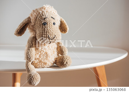 Lonely Plush Sheep on Minimal Table in Soft Light Lonely Plush Sheep on Minimal Table in Soft Light 135063068