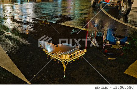 Golden Mount reflection in a puddle and a Tuk Tuk Golden Mount reflection in a puddle and a Tuk Tuk 135063580