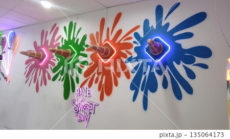 Colorful ice cream cone wall art with neon lights and vibrant splashes, creating a playful atmosphere for a sweet day celebration Colorful ice cream cone wall art with neon lights and vibrant splashes, creating a playful atmosphere for a sweet day celebration 135064173