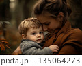 Mother and child sharing a tender moment in an autumn forest setting 135064273