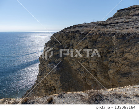 Rocky coast of the Black Sea with cliffs and clear sky, natural seascape landscape 135065164