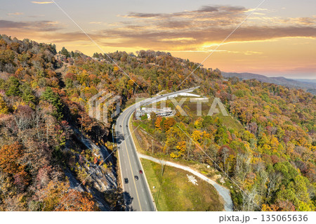 Highway road in North Carolina Appalachian mountains in fall season. Expressway lanes for fast passing of car traffic 135065636