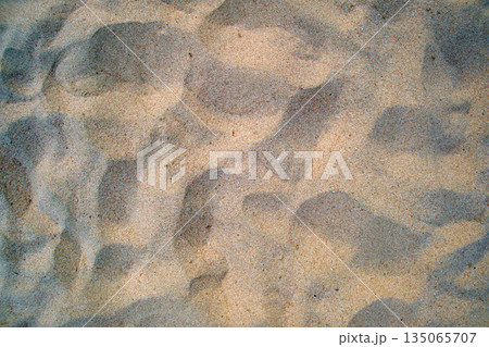 Flat view of clean yellow sand surface covering seaside beach. Sandy texture Flat view of clean yellow sand surface covering seaside beach. Sandy texture 135065707