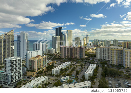 Expensive highrise hotels and condos on Atlantic ocean shore in Sunny Isles Beach city. American tourism infrastructure in southern Florida 135065723