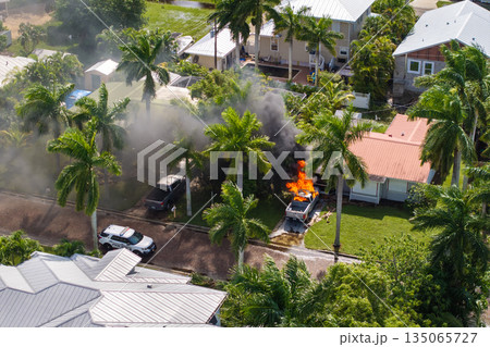 Emergency service personnel responding to car accident on Florida street. First responders extinguishing fire on burning vehicle 135065727