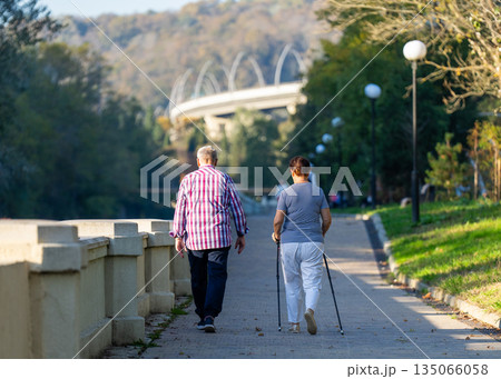 An elderly couple taking a walk in the fresh air. An elderly couple taking a walk in the fresh air. 135066058