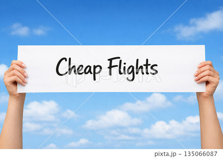 Hands holding a white paper sign that reads cheap flights against bright blue sky. Travel concept Hands holding a white paper sign that reads cheap flights against bright blue sky. Travel concept 135066087