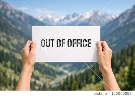 Out of office on white banner with two hand holding the banner. 135066097