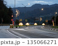 A tranquil asphalt road winds through the misty mountains of Krasnaya Polyana near Sochi, Russia, captured at dawn. 135066271