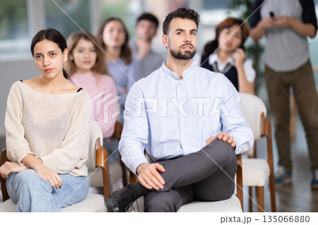 Group of young students listening during seminar in a modern classroom Group of young students listening during seminar in a modern classroom 135066880