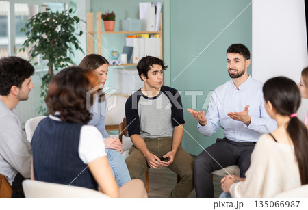 Group of students sitting in a circle and chatting 135066987