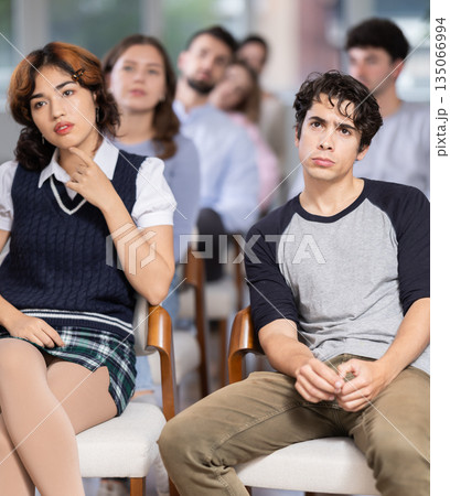 Group of young students listening during seminar in a modern classroom Group of young students listening during seminar in a modern classroom 135066994