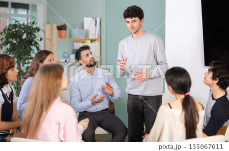 young man speaks to students in a classroom 135067011