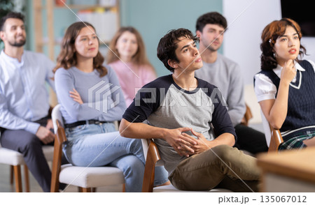 Group of young students listening during seminar in a modern classroom 135067012