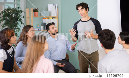 young man speaks to students in a classroom 135067064