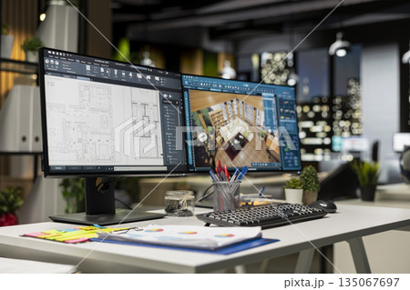 Contemporary office desk with CAD interface displaying digital blueprints and 3D renders of architectural projects. Ideal for architecture and construction professionals engaged in planning. 135067697