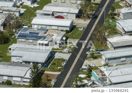 Destroyed by strong hurricane winds suburban houses in Florida mobile home residential area. Consequences of natural disaster 135068291