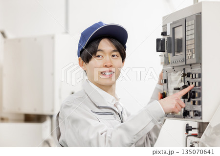 工場の操作盤の前で働く男性作業員 135070641
