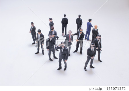 Group Of Suited Businesspeople In Sunglasses Standing Group Of Suited Businesspeople In Sunglasses Standing 135071372