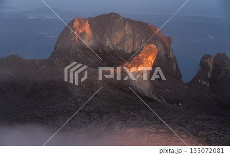 Spectacular view of the Alexandria's peak (3,994 m) lit by sunlight during morning on Mt Kinabalu the highest mountains on Borneo island. Spectacular view of the Alexandria's peak (3,994 m) lit by sunlight during morning on Mt Kinabalu the highest mountains on Borneo island. 135072081