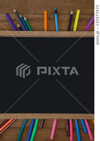 High angle view of blank chalkboard with colorful equipment High angle view of blank chalkboard with colorful equipment 135073472