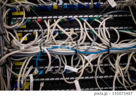 Network patch panel is being shown with tangled Ethernet cables and RJ45 connectors in flat design Network patch panel is being shown with tangled Ethernet cables and RJ45 connectors in flat design 135073487
