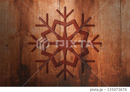 Displaying stylized six-armed snowflake flat design on vertical wooden planks, highlighting texture 135073678
