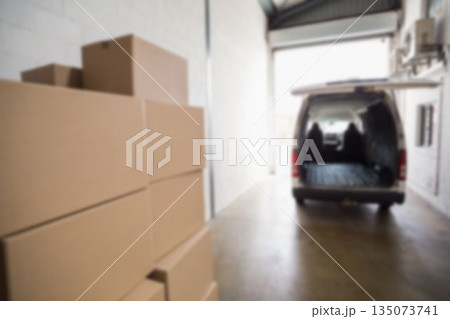 Van parked at warehouse with boxes in foreground 135073741