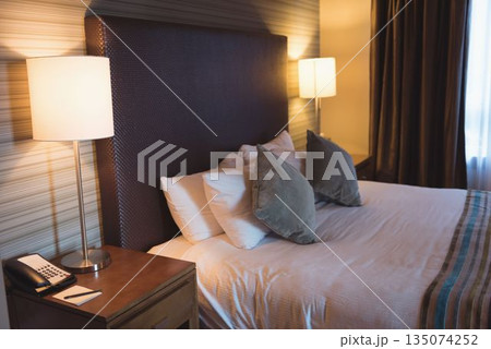 Pillows setting on bed in hotel Pillows setting on bed in hotel 135074252