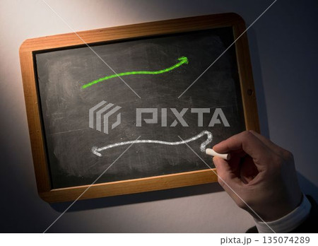 Hand drawing arrows on chalkboard Hand drawing arrows on chalkboard 135074289