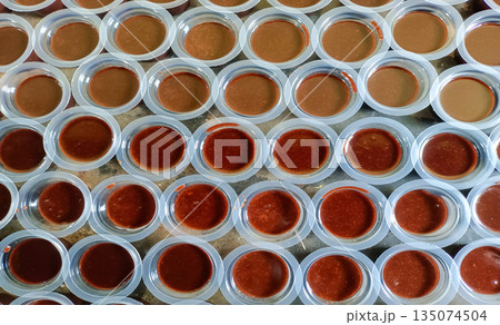 Overhead View Of Traditional Indonesian Chocolate Jelly Agar Agar In Small Plastic Cups 135074504