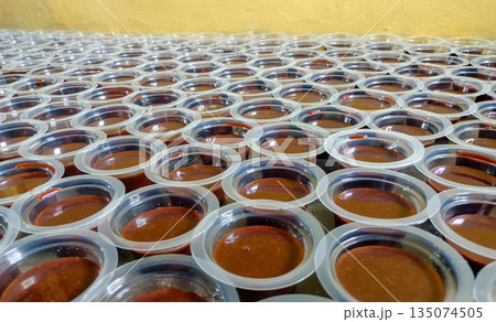 Batch Of Traditional Chocolate Agar Agar Pudding Cups Arranged On Table Background 135074505