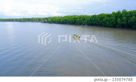 High Speed Boat Cruising Through Wide River Near Mangrove Forest High Speed Boat Cruising Through Wide River Near Mangrove Forest 135074788