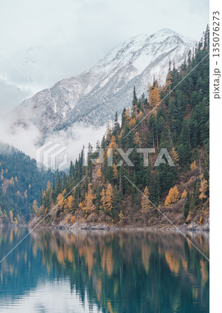Scenery Jiuzhaigou national park in Sichuan, China. Beautiful Long lake and snow mountain in Autumn season. Famous Landmark and Vacation near Chengdu, China. Asia travel concept 135076273