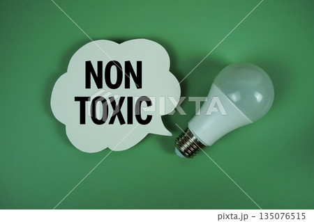 Non Toxic text with light bulb on green background Non Toxic text with light bulb on green background 135076515