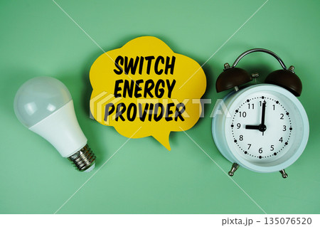 Switch Energy Provider with light bulb and alarm clock on green background Switch Energy Provider with light bulb and alarm clock on green background 135076520