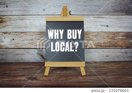 Why Buy Local? text on easel blackboard on wooden background 135076663