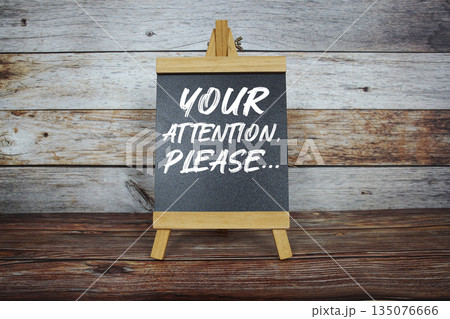 Your Attention, Please... text on easel blackboard on wooden background 135076666