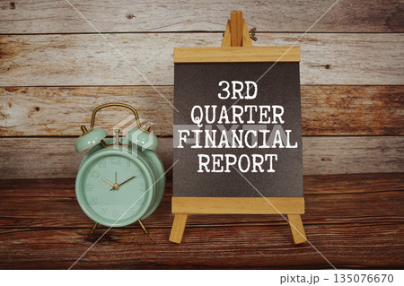 3rd Quarter Financial Report text on easel blackboard with alarm clock on wooden background 3rd Quarter Financial Report text on easel blackboard with alarm clock on wooden background 135076670