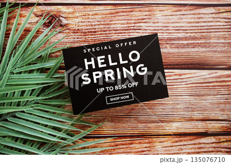 Hello Spring Sale 85% off with green leaf on wooden background Promotion Offer Discount Retail Shopping Concept 135076710