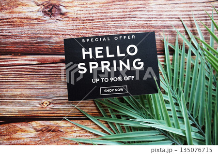 Hello Spring Sale 90% off with green leaf on wooden background Promotion Offer Discount Retail Shopping Concept 135076715