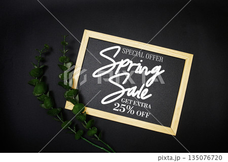 Spring Sale 25% off with green leaf on black background Promotion Offer Discount Retail Shopping Concept 135076720