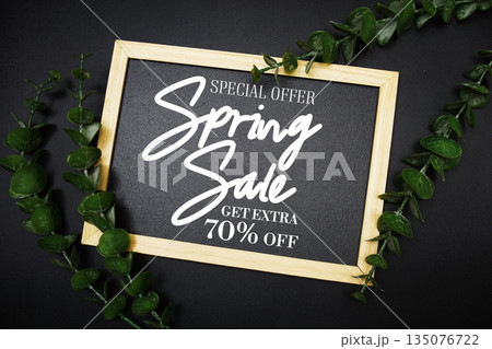 Spring Sale 70% off with green leaf on black background Promotion Offer Discount Retail Shopping Concept Spring Sale 70% off with green leaf on black background Promotion Offer Discount Retail Shopping Concept 135076722