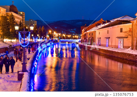 Otaru water canal and buildings along the waterfront outdoor in winter at nightime in Hokkaido , Otaru, Japan 135076753