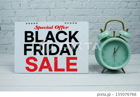 Black Friday Sale text Promotion and Marketing with alarm clock on wooden background Black Friday Sale text Promotion and Marketing with alarm clock on wooden background 135076766