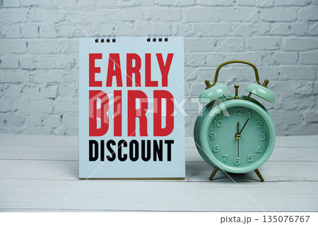 Early Bird Discount text Promotion and Marketing with alarm clock on wooden background Early Bird Discount text Promotion and Marketing with alarm clock on wooden background 135076767