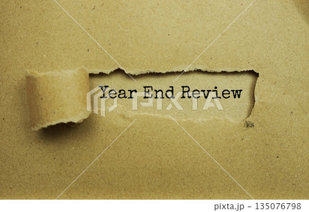 Year End Review message written on craft paper with torn paper background Year End Review message written on craft paper with torn paper background 135076798