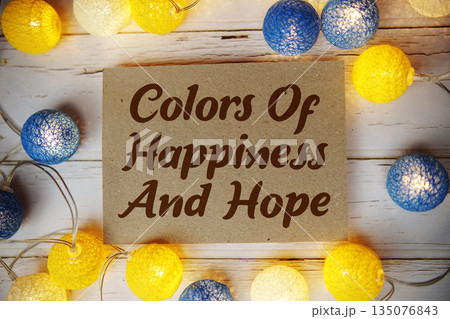 Colors Of Happiness And Hope text with LED cotton balls decorate on wooden background Colors Of Happiness And Hope text with LED cotton balls decorate on wooden background 135076843